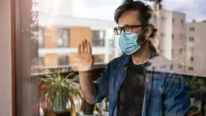 man in isolation at home for virus outbreak stockpack istock scaled e1630642370314 768x432.jpg